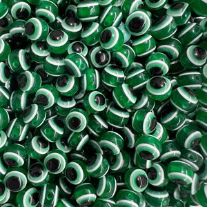 Macro view of dark green evil eye glass beads with handmade concentric circle patterns