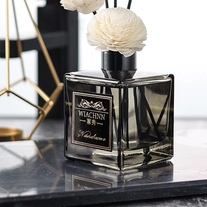 Gardenia reed diffuser set in smoky grey glass bottle with handmade sola flower