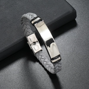Macro shot of grey braided leather men's bracelet with polished stainless steel clasp