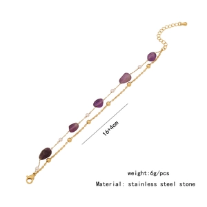 Detail of double-layer stainless steel bracelet with purple natural stones and shells