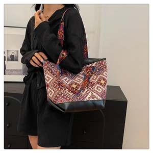 Close-up of ethnic jacquard tote bag featuring colorful geometric patterns and leather trim