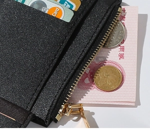 Detail view of the black PU leather wallet showing the metal zipper pocket and card slots