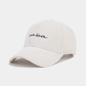 Close-up of beige corduroy fabric texture and black baba embroidery on baseball cap