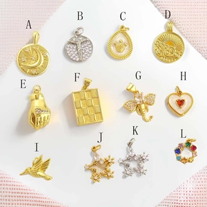 Macro view of 18k gold plated heart and celestial pendants with zircon inlay