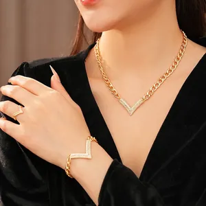 Luxury V-shaped jewelry set with gold necklace, bracelet and ring featuring pavé diamonds