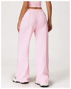 Rear view of pink high-waisted wide-leg sweatpants featuring a decorative seam detail