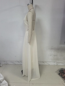 Detail of off-white lace sleeveless dress featuring elegant sheer hollow-out patterns