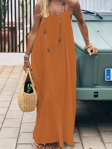 Close-up of bright orange backless loose maxi dress in lightweight summer fabric