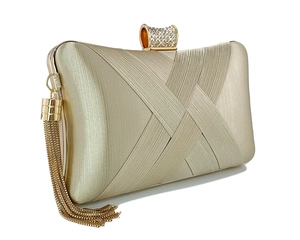Detail of golden woven evening clutch with rhinestone clasp and long metal fringe
