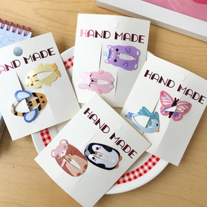 Set of eight colorful cartoon animal snap hair clips for girls including bee and unicorn