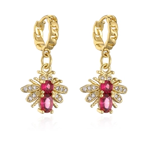 Close-up of gold-plated bee earrings featuring red and clear micro-set zircons