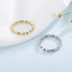 Detailed view of bamboo style adjustable open rings in polished gold and silver finishes