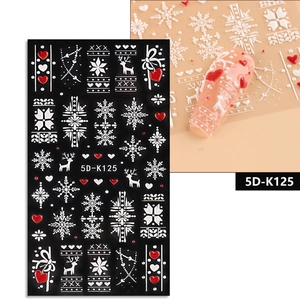 Detailed 5D embossed Christmas nail stickers with white snowflakes and reindeer patterns