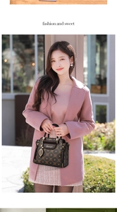 Detail of elegant monogram handbag with golden hardware and leaf charm on pink coat