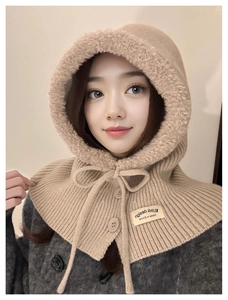 Detail of camel knit balaclava with plush lining, button closure and drawstring cord