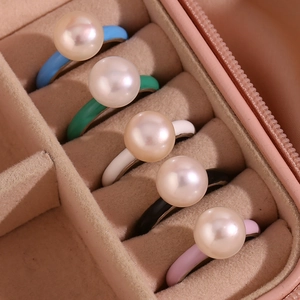 Colorful enamel dome rings with pearls set in a pink velvet jewelry display box