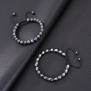 Detailed view of handmade magnetic hematite bracelets with faceted beads on black leather