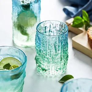 Blue-green gradient glacier glass cup with hammer texture on a marble tabletop