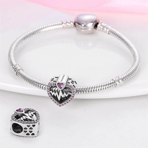 Detail of silver snake chain bracelet with heart pendant and pink stones for DIY jewelry