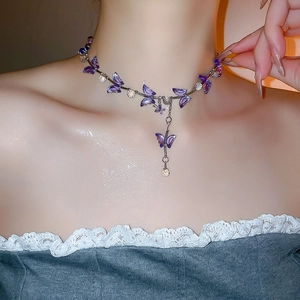 Detail of purple crystal butterfly choker necklace with elegant pendant on model