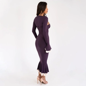 Side view of dark purple long sleeve bodycon dress featuring cutouts and ruffled fishtail hem