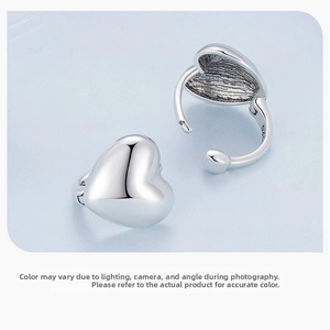 Detailed macro view of S925 sterling silver heart earrings showing the hallmark and hinge