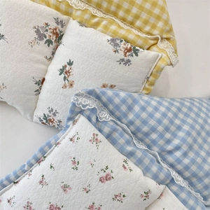 Macro view of macaron lattice storage bag with floral fabric and delicate lace trim