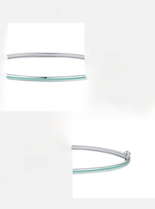 Detail of 925 sterling silver bangle featuring mint green enamel and star-shaped clasp