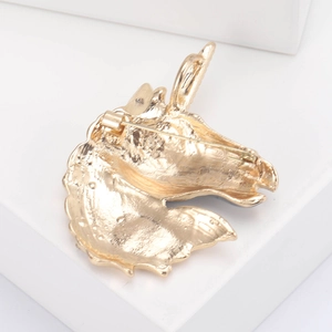 Golden unicorn head enamel brooch with rhinestone details and safe pin back