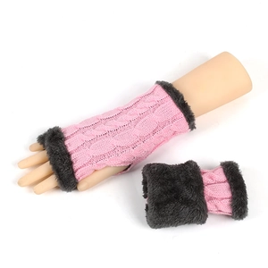 Detail of pink knitted fingerless gloves with dark grey faux fur trim and cable knit texture