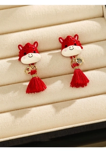 Detail of red cartoon horse earrings with golden coins and red silk tassels