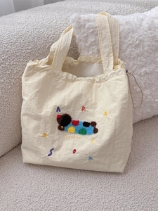 Cute beige nylon canvas tote with colorful cartoon embroidery and drawstring closure
