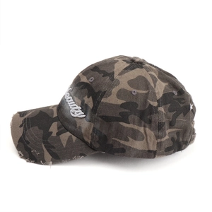 Close-up of 3D Beauty embroidery and distressed hole details on camouflage baseball cap