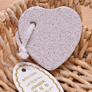 Macro shot of heart-shaped volcanic pumice stone with hanging rope in a beige basket