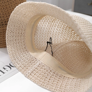 Detail of beige crochet bucket hat showing inner sweatband and adjustable drawstring