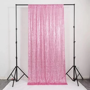 Pink sequin photography backdrop curtain on a professional stand for weddings and events