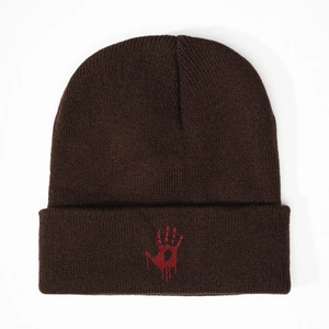 Detailed view of dark brown ribbed knit beanie featuring a red bloody handprint embroidery