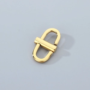 Close-up of a polished gold stainless steel chain adjuster buckle for bags and straps