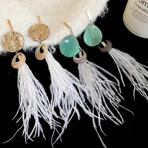 Boucles d'oreilles ethniques rondes en résine avec longues franges en plumes blanches et argent