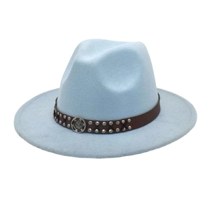 Detail of light blue fedora hat with brown leather rivet band and vintage metal badge