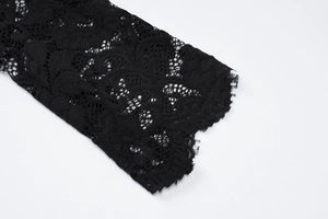 Detailed close-up showing the intricate black floral lace pattern on the sleeve cuff