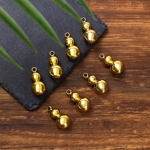 Detailed close-up of shiny gold calabash pendants with metal hanging rings for DIY crafts