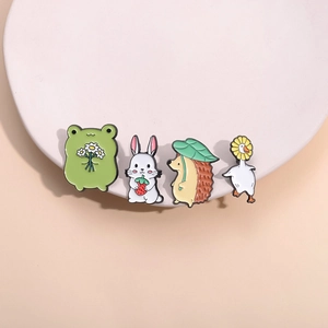 Set of four cute cartoon animal enamel pins featuring a rabbit, hedgehog, goose, and frog