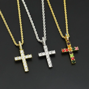Three hip hop cross necklaces in gold and silver with clear and multicolored rhinestones