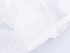 Macro shot of white floral jacquard mesh fabric and delicate lace texture details