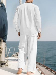 Men's white cotton linen vacation set with long sleeves and pants on a yacht deck