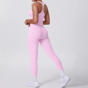 Detail view of pink yoga set showing high-waisted leggings and racerback sports bra