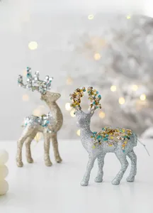 Detail of glittered Christmas reindeer ornaments with sequins and elegant bokeh background