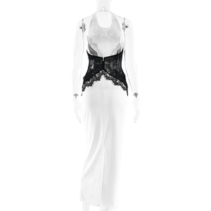 Detail view of the elegant backless design with black eyelash lace on a white maxi dress