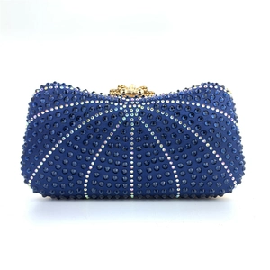 Close-up of sparkling blue rhinestones and gold clasp on a luxury evening clutch bag